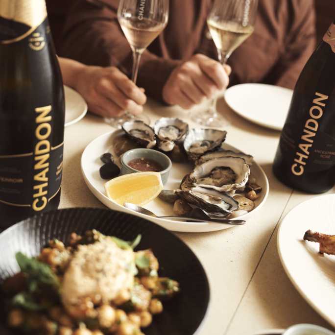 Dinning at the CHANDON BrandHome in Australia with CHANDON Bottle and Oyesters