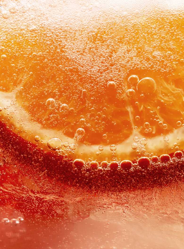 Une image attrayante mettant en scène la gamme de produits Chandon Spritz. Trois bouteilles de différentes saveurs sont présentées aux côtés de trois verres garnis d'agrumes, de romarin et de menthe, servis de CHANDON Orange Peels & Spices, Lemon & Verbena et Berries & Hibiscus.