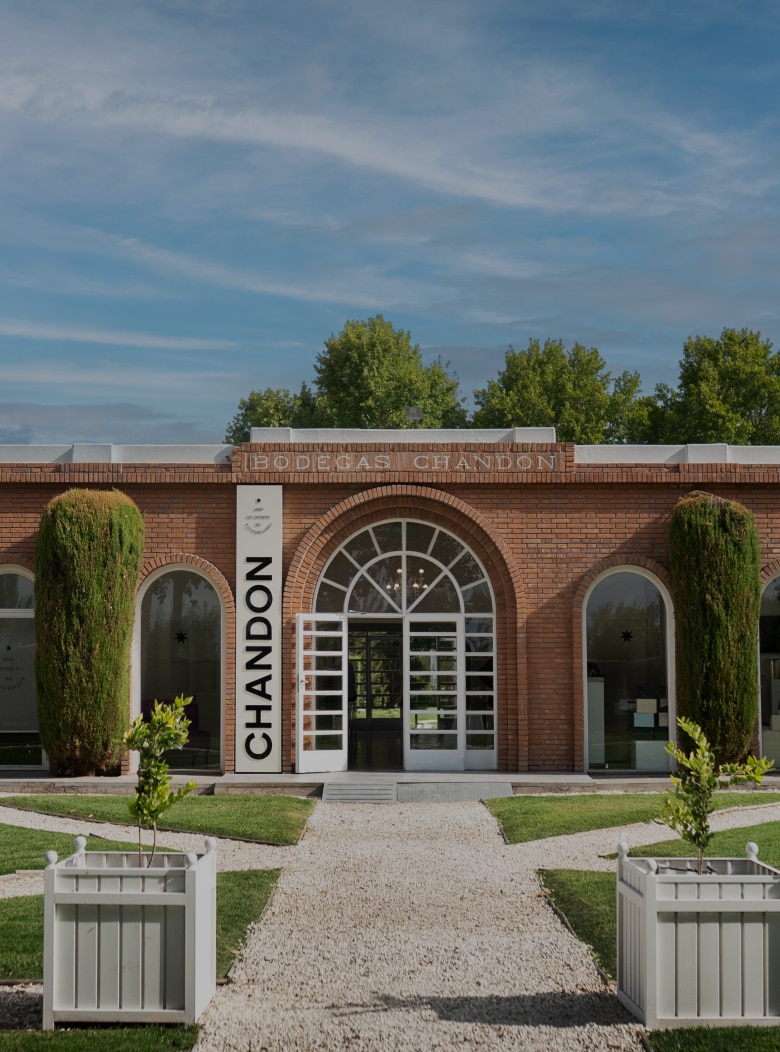 CHANDON Argentina winery building exterior in Mendoza, showcasing its brick architecture and gardens.